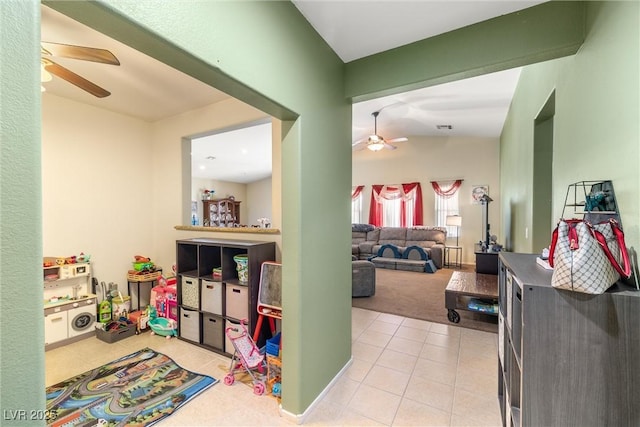 game room featuring lofted ceiling, light tile patterned floors, and ceiling fan