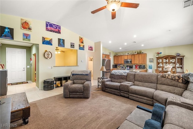 tiled living room with lofted ceiling and ceiling fan