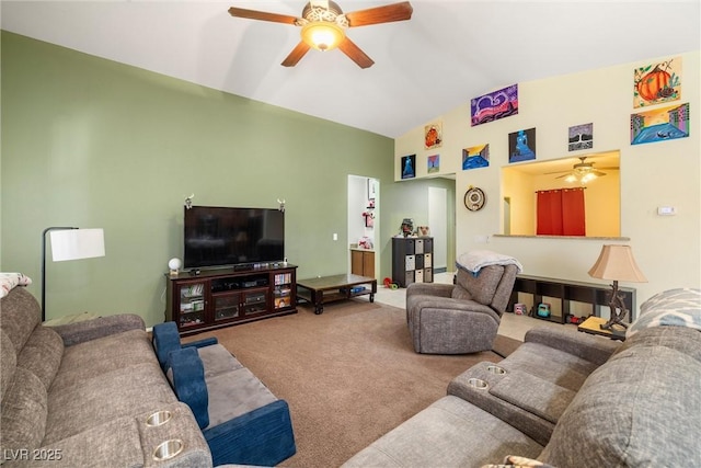 living room featuring ceiling fan, carpet flooring, and vaulted ceiling