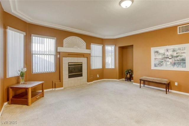 living room with light colored carpet and a tiled fireplace