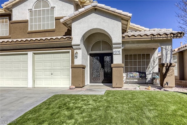 view of front of property with a garage, a front lawn, and french doors