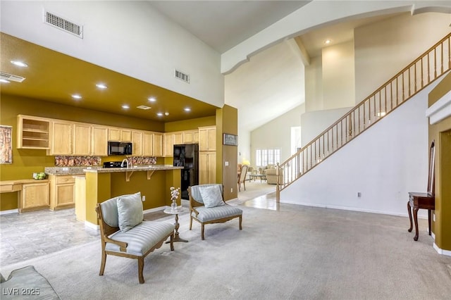 living room featuring light carpet and a high ceiling