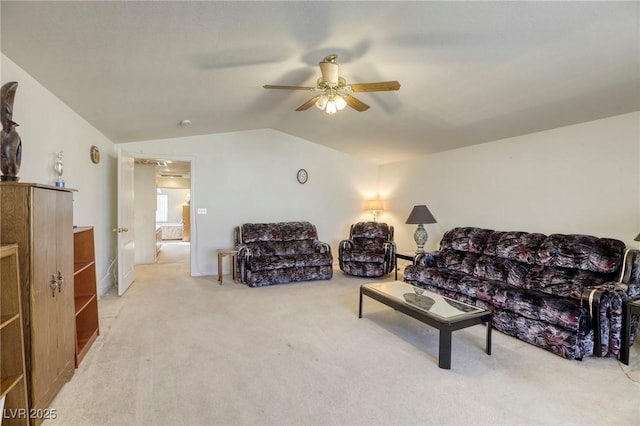 living room featuring ceiling fan, vaulted ceiling, and carpet flooring