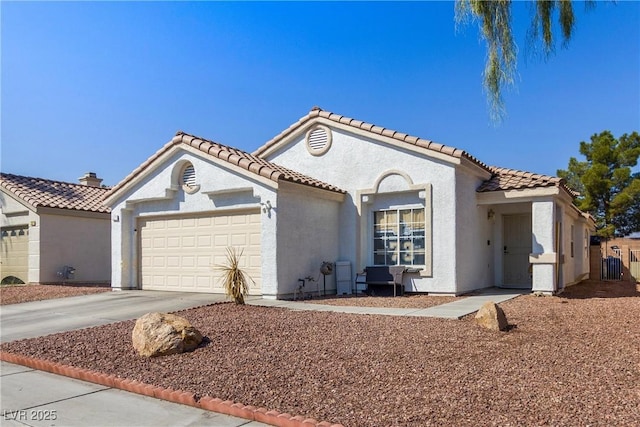 mediterranean / spanish-style home with a garage