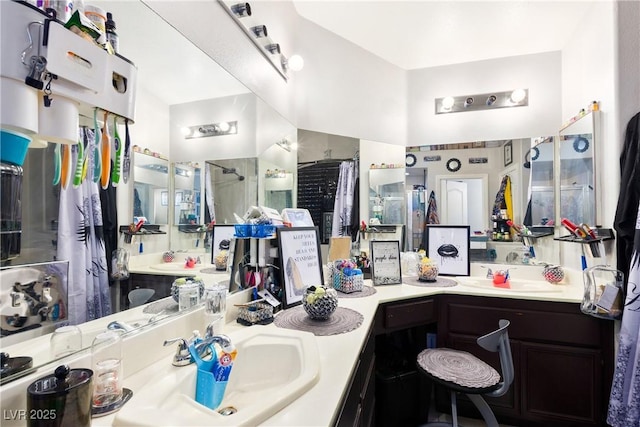 bathroom featuring walk in shower and vanity