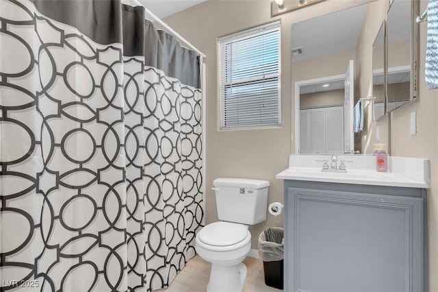 bathroom featuring toilet and vanity