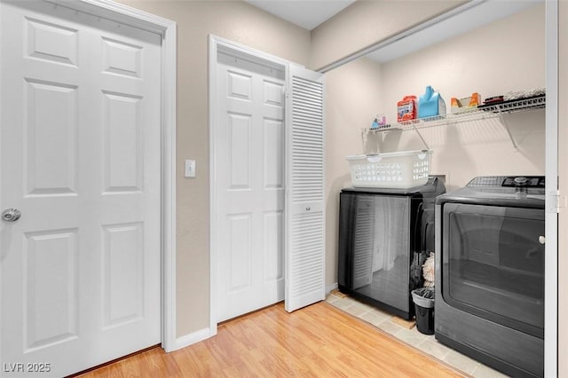 washroom with light wood-type flooring and separate washer and dryer