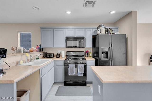 kitchen featuring gray cabinets, sink, black appliances, and kitchen peninsula