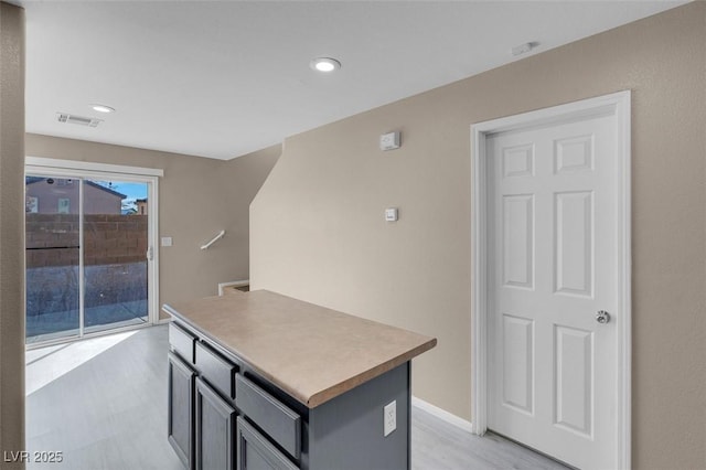 kitchen with light wood-type flooring and a center island