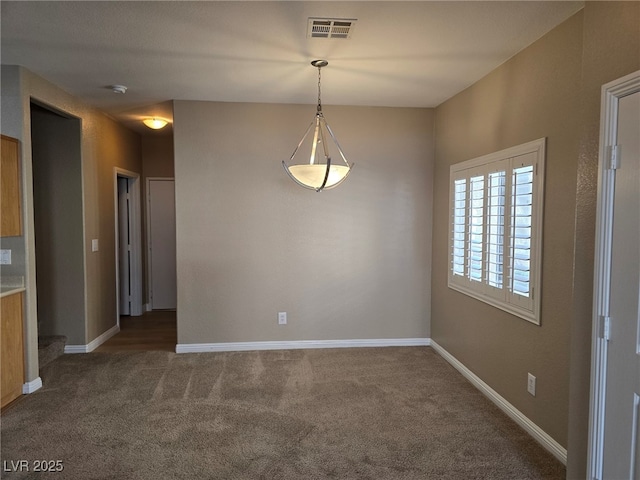 empty room featuring stairway, baseboards, visible vents, and dark carpet