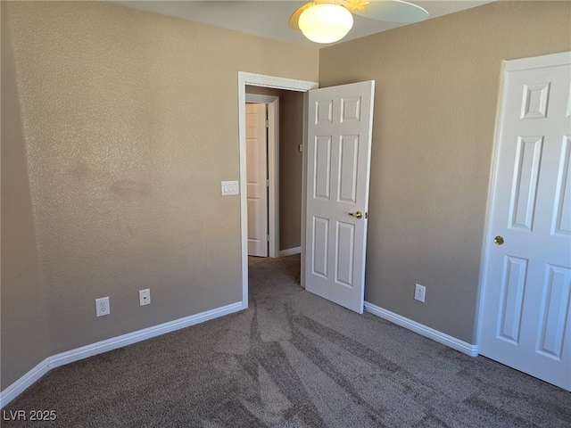 unfurnished bedroom with carpet flooring and baseboards