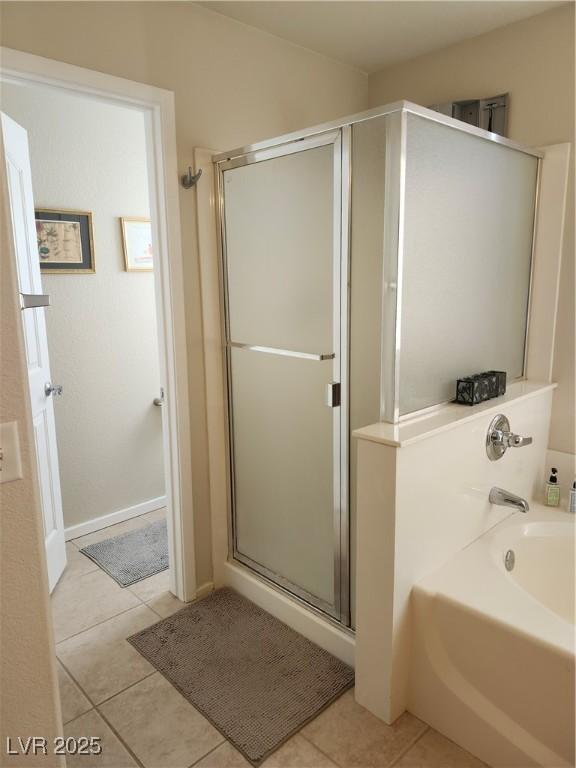 bathroom featuring shower with separate bathtub and tile patterned flooring