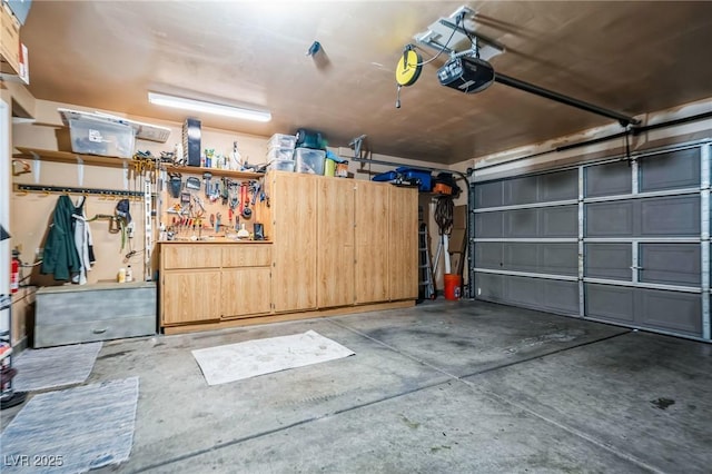 garage featuring a garage door opener and a workshop area