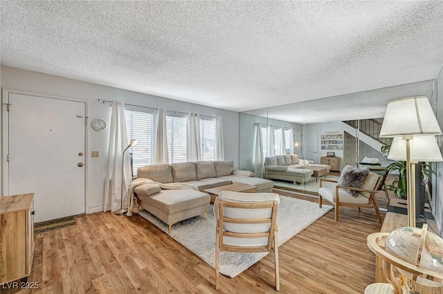 living room featuring a textured ceiling and light hardwood / wood-style floors