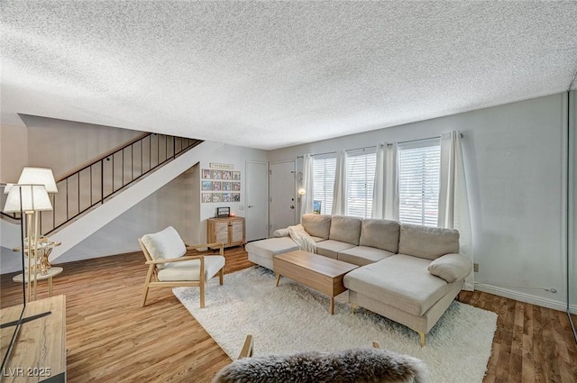 living room featuring a textured ceiling and hardwood / wood-style flooring