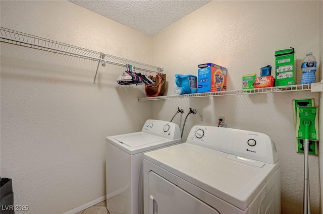 laundry area featuring tile patterned floors, independent washer and dryer, and a textured ceiling