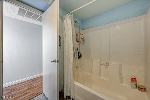 bathroom featuring tile patterned flooring and shower / bath combination with curtain