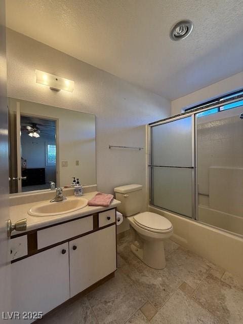 full bathroom with toilet, vanity, shower / bath combination with glass door, and a textured ceiling