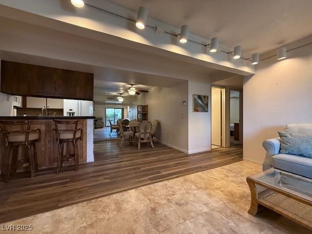 living room featuring ceiling fan and hardwood / wood-style flooring