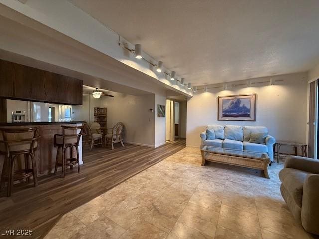 living room with ceiling fan and hardwood / wood-style flooring