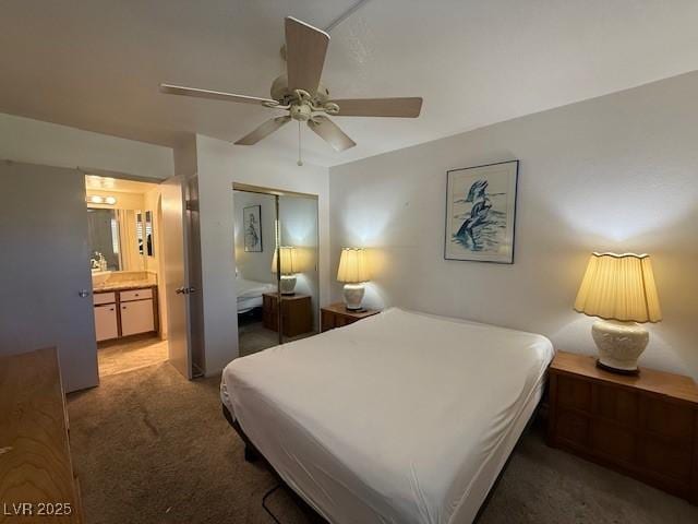 bedroom with ceiling fan, a closet, ensuite bathroom, and dark carpet