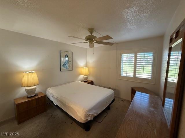 bedroom featuring a textured ceiling, ceiling fan, and carpet floors