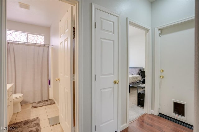 full bathroom with vanity, toilet, tile patterned floors, and shower / tub combo with curtain