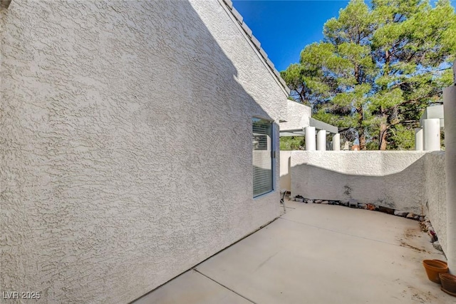 view of side of property with a patio area