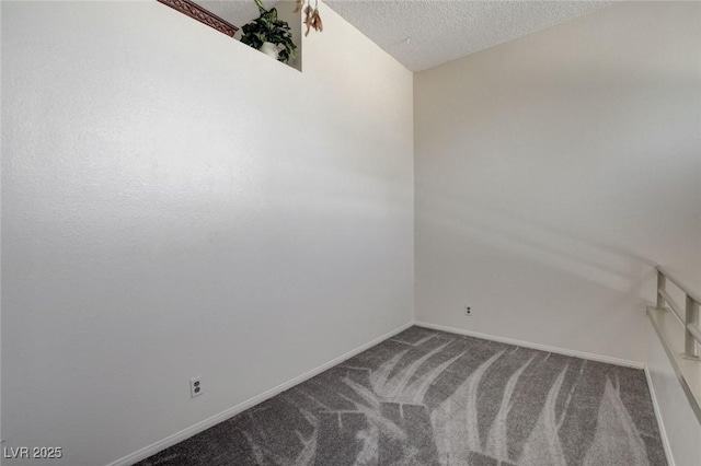 empty room with a textured ceiling and carpet