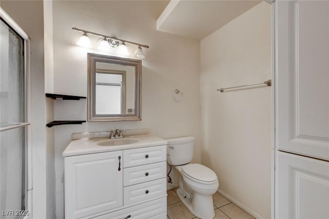 bathroom featuring toilet, vanity, and tile patterned floors