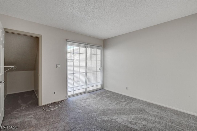 carpeted spare room with a textured ceiling