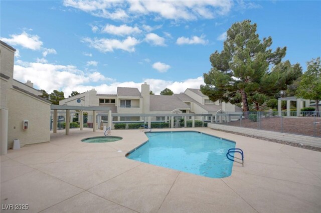 view of swimming pool featuring a community hot tub and a patio area