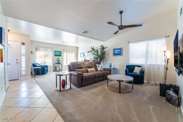 tiled living room featuring ceiling fan and vaulted ceiling