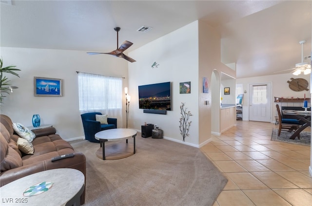 tiled living room featuring vaulted ceiling and ceiling fan