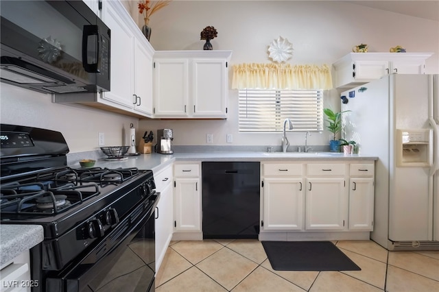 kitchen featuring sink, white cabinetry, black appliances, and light tile patterned flooring