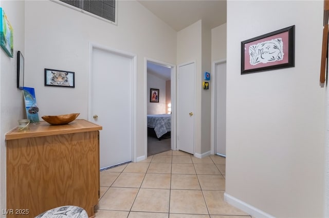 hall with light tile patterned floors