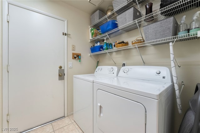 washroom featuring light tile patterned floors and washer and clothes dryer