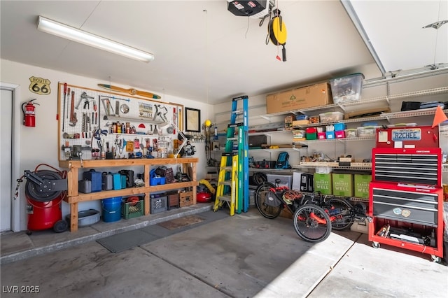 garage featuring a garage door opener and a workshop area