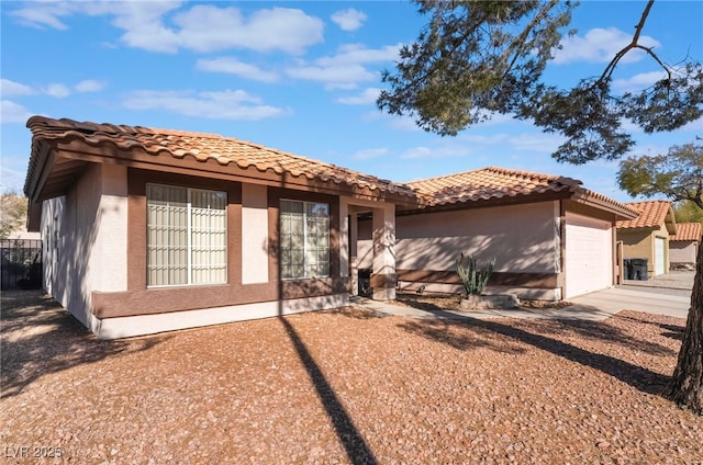 mediterranean / spanish-style home with a garage