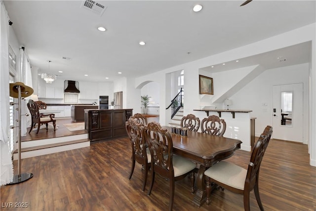 dining area with an inviting chandelier and hardwood / wood-style floors