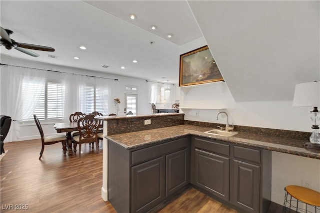 kitchen with hardwood / wood-style flooring, sink, a wealth of natural light, and kitchen peninsula