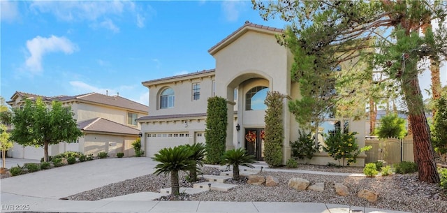 mediterranean / spanish house with a garage