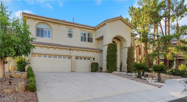 mediterranean / spanish home featuring a garage