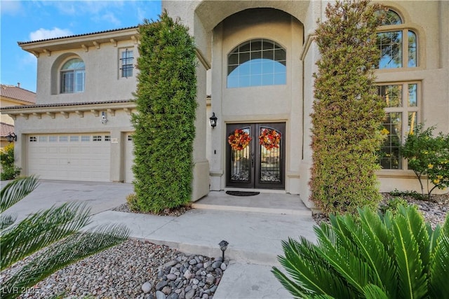 doorway to property featuring a garage and french doors