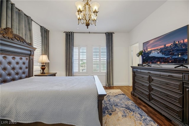 bedroom with dark wood-type flooring and an inviting chandelier