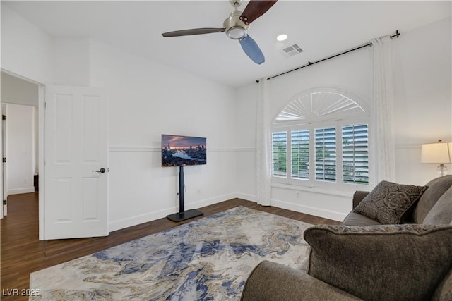 living area with ceiling fan and dark hardwood / wood-style floors