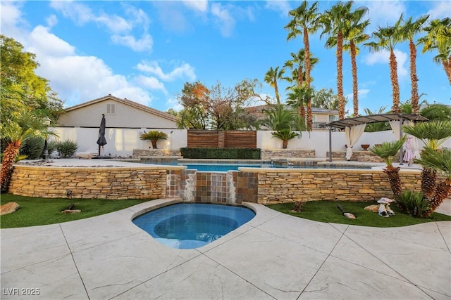 view of pool with a patio, pool water feature, and a pergola