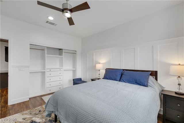 bedroom with ceiling fan, a closet, and dark hardwood / wood-style flooring