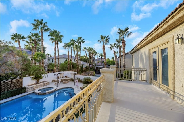 view of swimming pool featuring an in ground hot tub