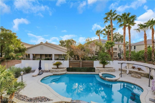 view of swimming pool featuring an in ground hot tub and a patio